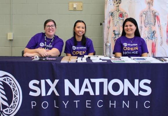 three people sitting behind a table