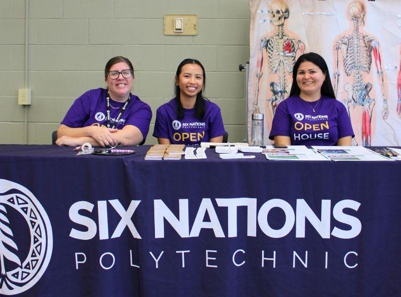 three people sitting behind a table
