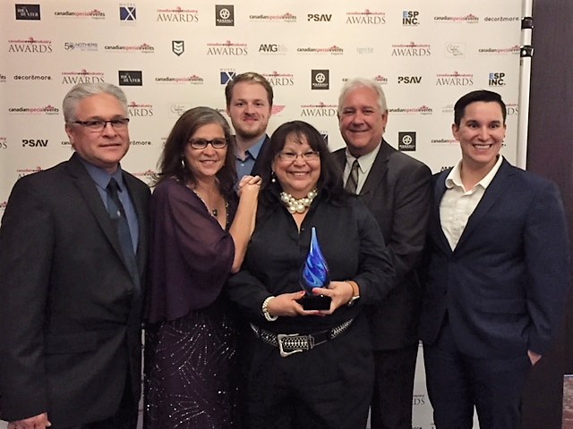 Group of conference organizers holding award