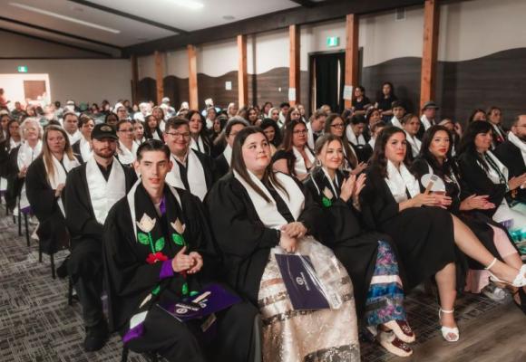 students at a graduation sitting in hall