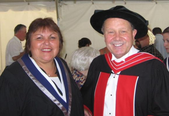 linda staats standing next to a man