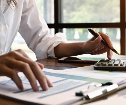 Woman using calculator