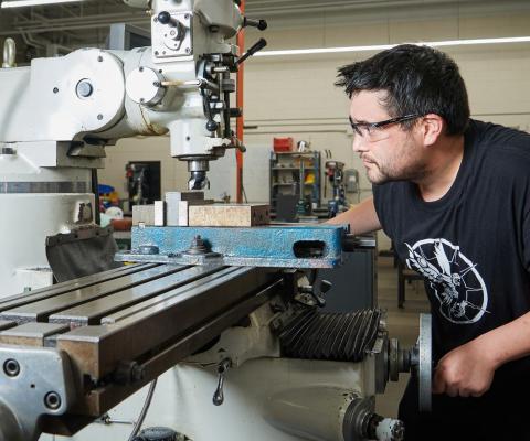 student using drill press