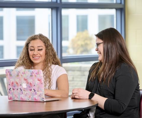 two students at a laptop