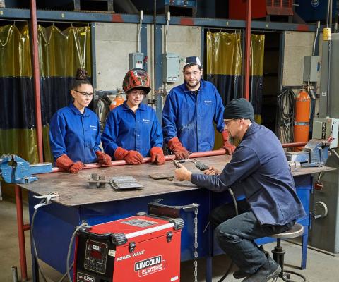 welding students with instructor