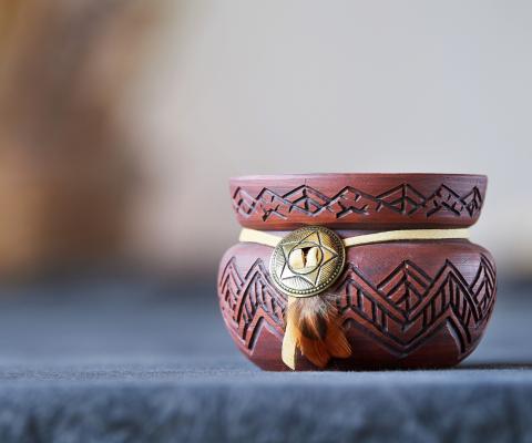 a clay jar with carvings on it