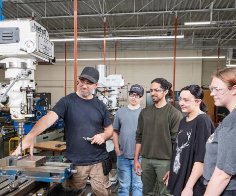 machining students learning from teacher