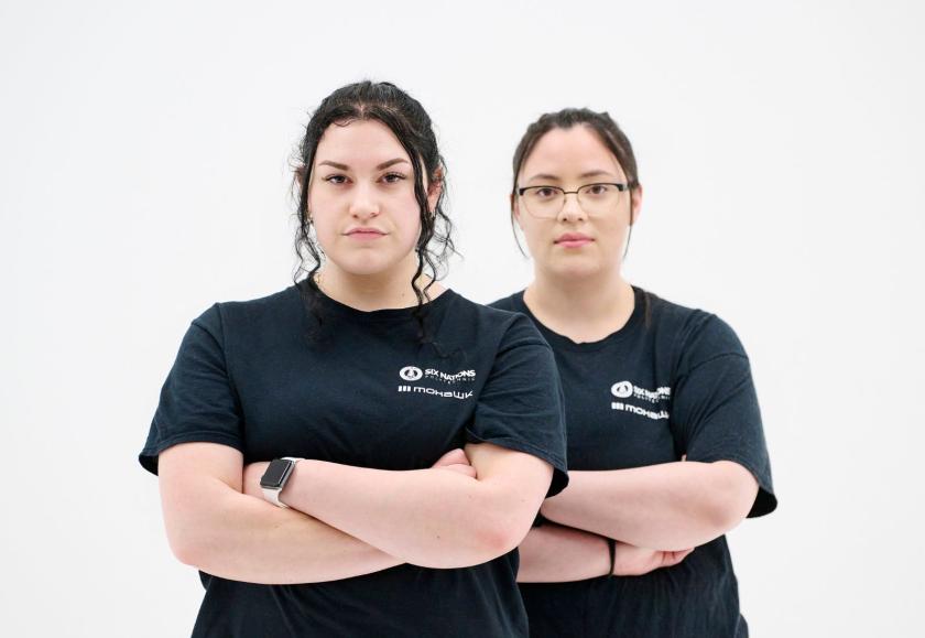 two students with their arms crossed