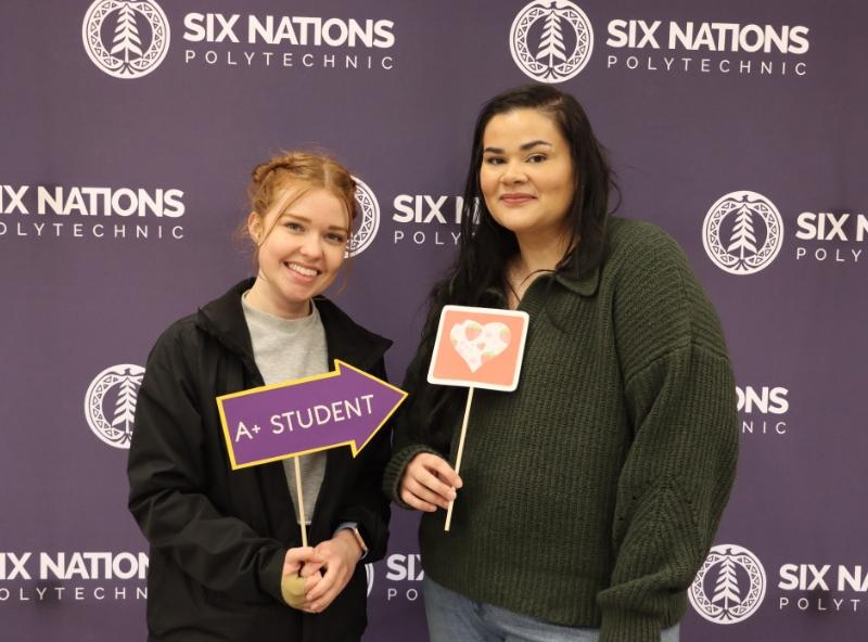 two women holding school signs