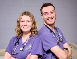 two nurses standing back-to-back