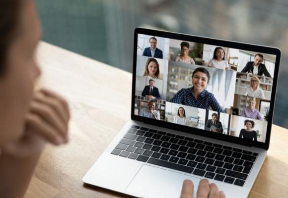 a laptop with a video call on the screen