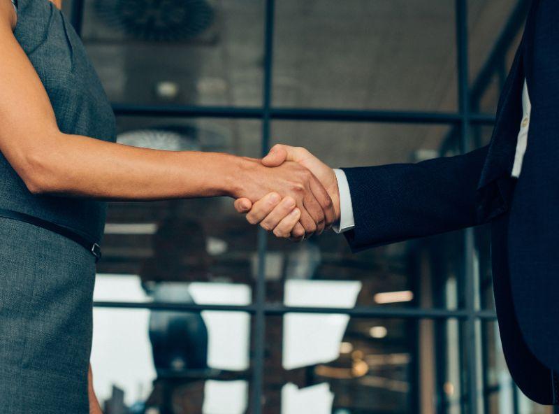 man and woman shaking hands